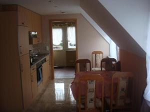 a kitchen with a table and chairs in a room at Agroturystyka Düsselkamp Tumiany in Barczewo