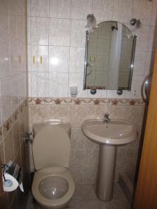 a bathroom with a toilet and a sink at Guesthouse Olimp in Sozopol