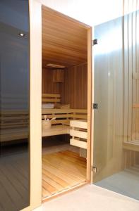 a room with a closet with a sliding glass door at Europeum Hotel in Wrocław
