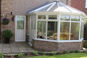 a greenhouse with a glass roof on a house at Bridge End in Northallerton +7 photos