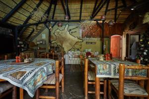 a dining room with two tables and chairs at African Kwela Guest House in Windhoek