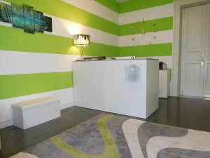 a room with green and white striped walls and a table at Hotel Etnea Royal Suites in Catania