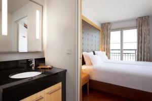 Postel nebo postele na pokoji v ubytování Relais Spa Chessy Val d'Europe