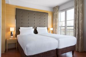 Postel nebo postele na pokoji v ubytování Relais Spa Chessy Val d'Europe