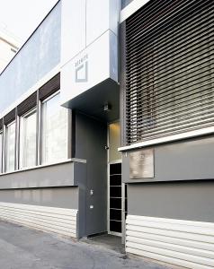 a facade of a building with a sign on it at BB Hotels Aparthotel Desuite in Milan