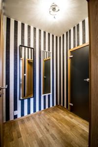 a room with two mirrors on a striped wall at Stylish Apartments close to Eden Garden in Prague