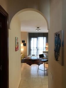 a living room with an archway and a living room with a motorcycle in it at Casa Natalie in El Cotillo