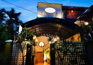 a building with an archway with a staircase in front at Prantara Heritage Suites in Phnom Penh