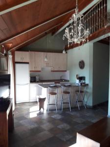 a kitchen with a table and chairs and a chandelier at PLAZA DE LA VILLA 24 in Rascafría