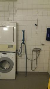 a bathroom with a washing machine and a toilet at Nice spacious home in Vaasa