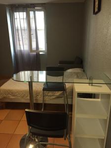 a table and chairs in a room with a bed at A la confluence in Lyon