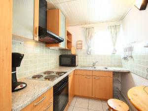 a kitchen with a sink and a stove top oven at Holiday Home Costabella by Interhome in Marbella