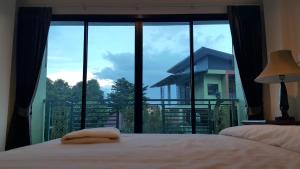 Ένα ή περισσότερα κρεβάτια σε δωμάτιο στο Garden Corner Resort & Hotel