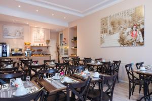 a restaurant with tables and chairs in a room at L'Ouest Hotel in Paris