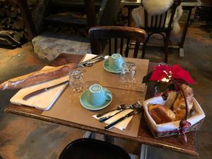 a table with a plate of food on it at La Cour Sainte Catherine demeure de charme in Honfleur