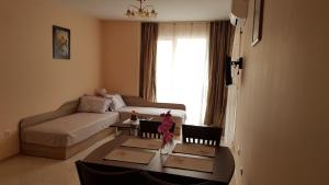a living room with a couch and a table at Zefira Apartments in Pomorie