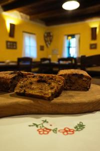 two pieces of bread sitting on a wooden cutting board at Pomona Relaxing Nature Guest House in Rogaška Slatina