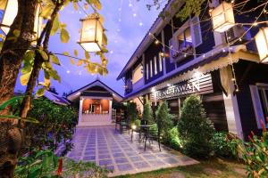 an exterior view of a house with a patio at Vieng Tawan Sukhothai Hotel in Sukhothai