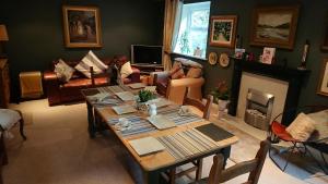 a living room with a table and a fireplace at Teardrop Cottage in Knaresborough