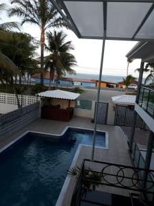 a swimming pool with a view of the ocean at Areia do Atlantico Hotel in Porto Seguro