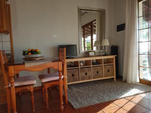 a living room with a table and a mirror at Bungalows Aldani in Tijarafe