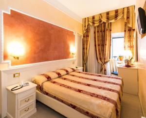 Postel nebo postele na pokoji v ubytování Hotel Erdarelli