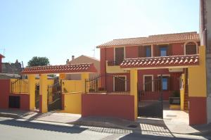 a row of colorful houses in a street at L'Agave in SantʼAntìoco