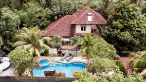 an aerial view of a house with a swimming pool at Sari Inn Kuta Lombok in Kuta Lombok