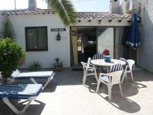 a patio with a table and chairs and an umbrella at Holiday Home Etxe Zuri by Interhome in Calpe