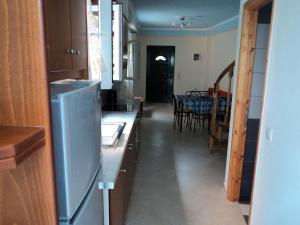 a kitchen with a refrigerator and a dining room at Maistralis House in Agios Gordios