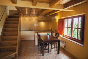 a kitchen with a table and chairs and a staircase at Sa Perafita - MF in Cadaqués