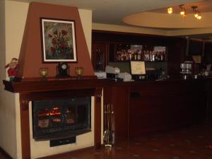 a bar with a fireplace in a room at Hotel Šator in Bitola