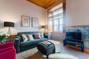 a living room with a couch and a tv at Baixa Downtown Fabulous And Sophisticate Apartment With Elevator 18th Century Building in Lisbon
