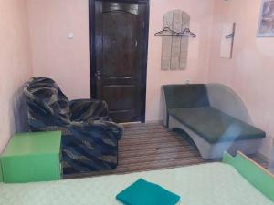 a room with two chairs and a door at Hotel Europlus in Poltava