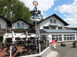 een restaurant met een bord voor een gebouw bij Hotel Pappelhof in Weidenbach