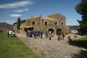 people standing around a stone building at Sa Perafita - MF in Cadaqués
