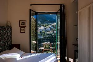 a bedroom with a bed and a view of a city at La Moresca in Ravello