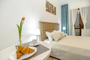 a bedroom with a bed and a table with a plate of food at ConceptHT Regim Hotelier in Iaşi