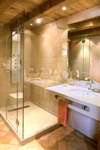 
a bathroom with a sink, shower, and mirror at Sa Perafita - MF in Cadaqués
