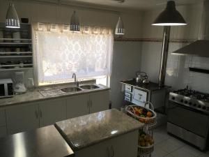 a kitchen with a sink and a window at Casa Florecer in Contulmo +10 photos
