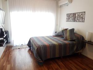 Una cama o camas en una habitación de Rincón Rosarino