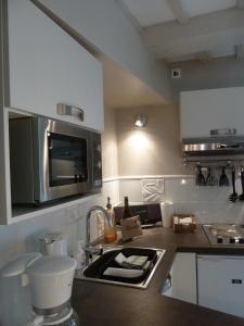 a kitchen with a sink and a microwave at La Berlue Bayeux in Saint-Vigor-le-Grand +58 photos