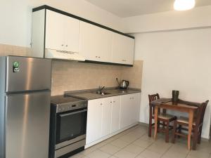 Kuchyň nebo kuchyňský kout v ubytování Kimata Apartments