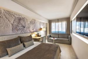 a bedroom with a large bed and a large window at Sallés Hotel Pere IV in Barcelona