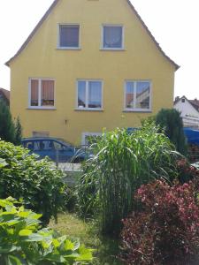 uma casa amarela com um carro estacionado em frente em im gelben Haus em Trusen