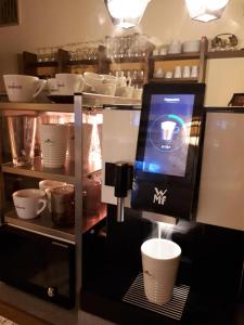 a coffee machine with cups on display in a store at Pension Kreuzinger, 5310 Tiefgraben in Mondsee +62 photos