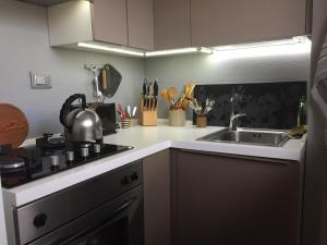 a small kitchen with a sink and a stove at Penthouseinrome in Rome