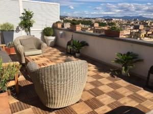 a balcony with chairs and a view of a city at Penthouseinrome in Rome