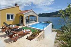 a villa with a swimming pool and a house at Villa Šeparović in Vela Luka