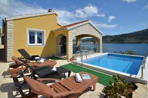 a villa with a swimming pool and a house at Villa Šeparović in Vela Luka